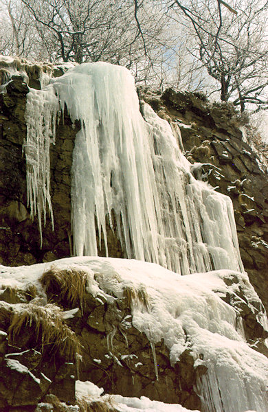 Gefrorener Wasserfall an der Felswand unterhalb des Gipfels des Klíč (Kleis).