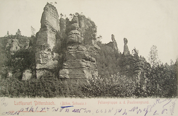 This picture postcard shows the rocky formations over the lower part of the Pavlínino údolí near Jetřichovice.