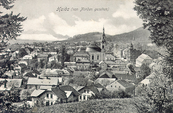 On this picture postcard from the first years of the 20th century we see the town centre dominated by the church Assumption of the Virgin. On the right of it the monumental building of the former savings bank is seen which partially is hidden behind of the town hall.
