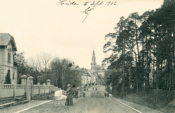 This picture postcard from about 1910 shows the street at present named Sloupská-ulice which leads to the market place with the church Asumption of the Virgin.