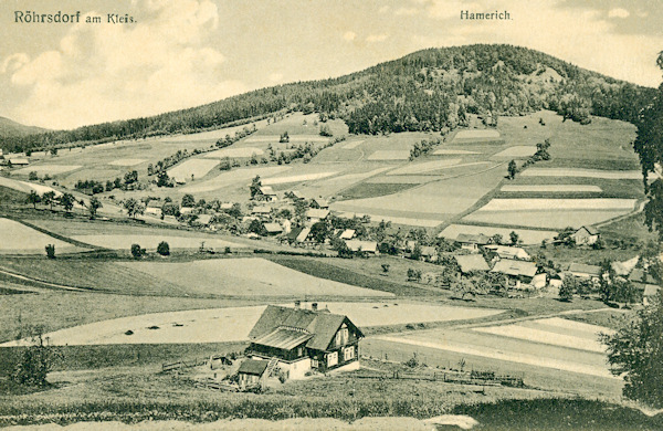 Na této pohlednici vidíme horní část obce v údolí pod Rousínovským vrchem ze svahu Sokolíku.